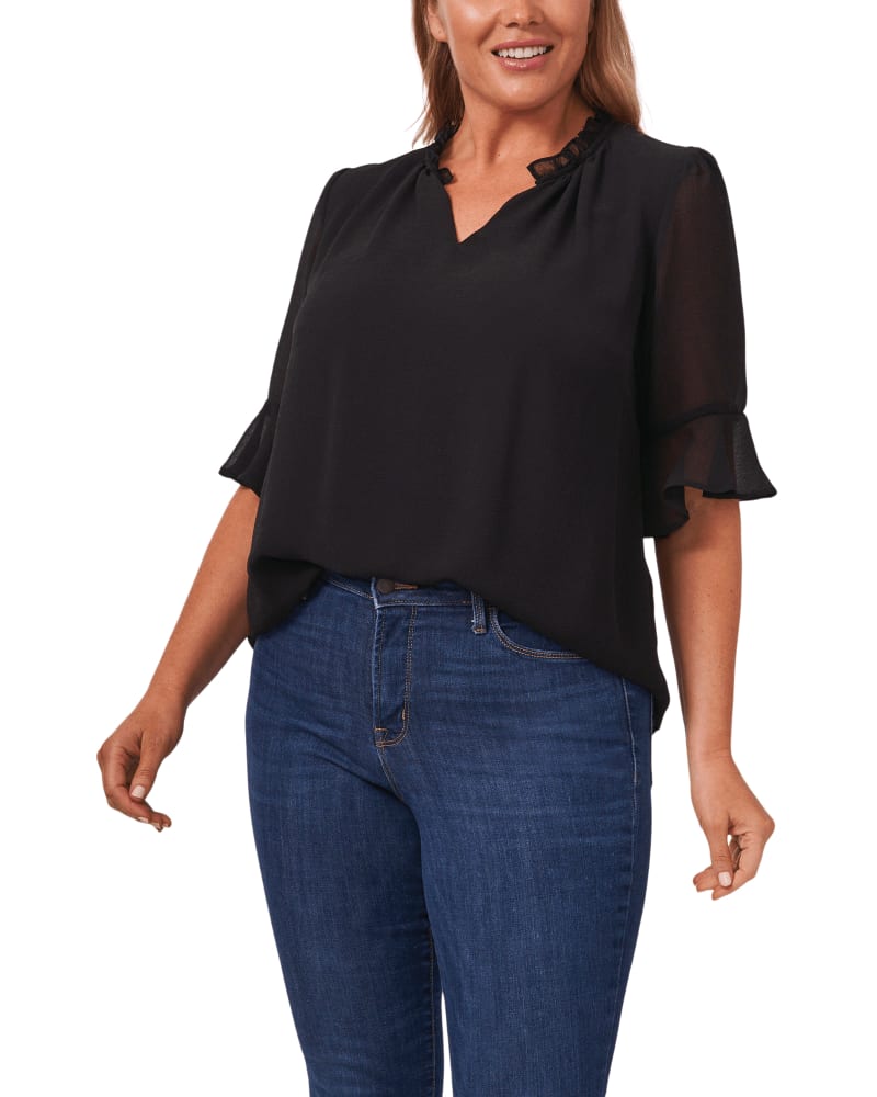 Front of a model wearing a size 1X Delia Sheer Ruffled Blouse in RICH BLACK by CeCe. | dia_product_style_image_id:263641